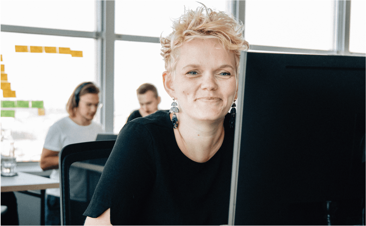 MVPF employee smiling past her desk