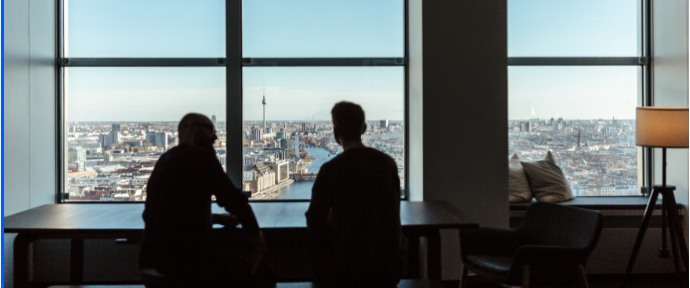 two employees working at their desks with amaizing office views